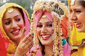 Girls share a joke as they wait for their turn during the youth festival in Chandigarh on Monday. 