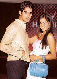 Models display leather outfits and bags for the autumn/winter collection, 2006, at a fashion show in Kolkata 
