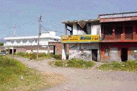 Industrial units are sandwiched between fields and residential areas, indicating poor planning