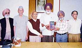 Prof Niranjan Tasneems The Lost Meaning being released by the Principal of the Government College for Boys, Mr Malkiat Singh