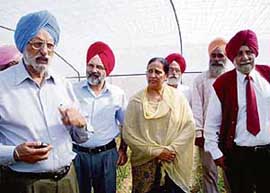 The Chairman of the Punjab State Farmers Commission, Dr G.S. Kalkat, and the PAU Vice-Chancellor, Dr K.S. Aulakh, at a field day at Nawan Jatpur village (Hoshiarpur) on Wednesday.
