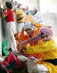 Students of Spring Dale Senior Secondary Public School tie turbans during the birth anniversary week celebrations of Guru Nanak Dev in Ludhiana on Wednesday.