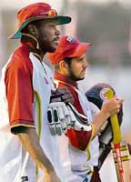 West Indian cricketers Chris Gayle and Ramnaresh Sarwan arrive for a training session while South African pacers Makhaya Ntini and Shaun Pollock attend a practice session in Jaipur on Wednesday. 