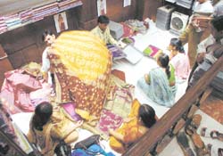 A shopkeeper displays his wares to customers after markets in the Capital re-opened following a bandh by traders to protest against sealing drive.