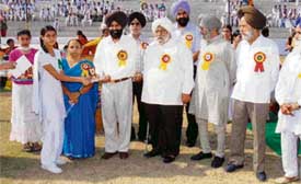 A winner of the annual athletic meet of GN Model Senior Secondary School receives the prize at Guru Nanak Stadium in Ludhiana on Wednesday