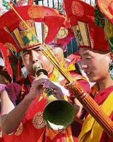 Buddhist monks play musical instruments to greet Tibetan Spiritual leader Ugyen thinley dorje outside Bagdogra airport, in Siliguri, on Thursday. Dorje was on his way to attend a 14-day-long Buddhist religious conference at Mirik in Darjeeling hills.
