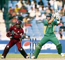 South Africas Herschelle Gibbs plays a shot as West Indies wicketkeeper Carlton Baugh looks on during the semifinal of the ICC Champions Trophy in Jaipur on Thursday