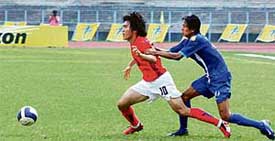Indias Elangbam Horohito tries to stop South Koreas Shim Young Sung during an AFC Youth Championship match at Yuba Bharati Stadium in Kolkata on Thursday. Korea won 3-0
