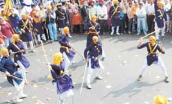 Soldiers of Faith: Sikh youths displaying their martial skills during a procession on the eve of Guru Nanak Devjis birth anniversary.