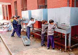 Children drink water from tanks at the Government Senior Secondary School, Sector 38 