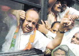 President of Delhi BJP unit Dr Harsh Vardhan being carted away by the police after a demonstration against the sealing drive at Vikas Marg. 