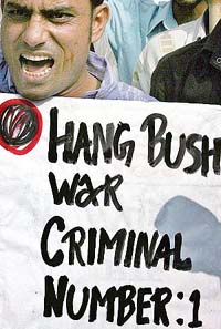 ANTI-US PROTEST: An activist from the CPM holds a placard and raises anti-US slogans during a protest against the death sentence against Saddam Hussein in New Delhi 