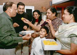 Mr Jawahar Goyal (extreme left) celebrates the victory of his first cousin, Mr Raj Goyle, with his family members in Chandigarh on Wednesday. 