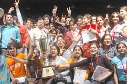 Jubilant students of the DAV Institute of Engineering and Technology mill around the overall trophy they won in Zonal Youth Festival organised by PTU at Lovely Institutes in Phagwara