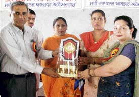 Mr Arvind Malhotra, secretary, Shanti Tara College, and others felicitate Dr Jyoti Hind at Akbarpur Chhanna, near Mandi Ahmedgarh, on Wednesday.