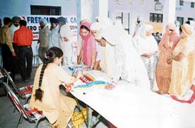 Patients get themselves registered at a free medical camp held at Ropalon village, near Samrala, on Wednesday.