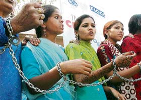 Bhopal Gas victims demonstrate, tied to one another with chains during the India Chem Conference-2006 in Mumbai