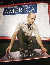 Worker David Plevan sets the stage for US House of Representatives Minority leader Nancy Pelosis (D-CA) election night party at a Washington hotel