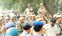 Personnel of the Delhi Police, the RAF and other forces keep vigil during the sealing of unauthorised commercial establishments by the MCD at Lajpat Nagar in the Capital
