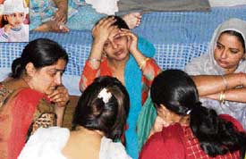 Grieving relatives of Anmoldeep Kaur (inset), who died in a road accident in Ludhiana on