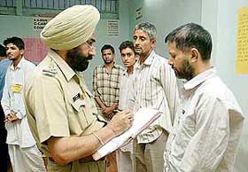 A police officer records the statement of inmates of a private drug de-addiction centre following a raid in Bathinda on Tuesday night.
