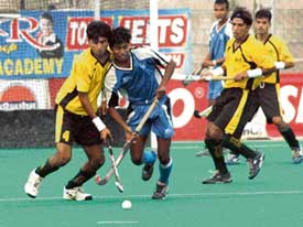 Pakistans Shadman Club and SAI players fight for the ball during a match at the 23rd Indian Oil Surjit Hockey Tournament at the Olympian Surjit Hockey Stadium in Jalandhar on Thursday