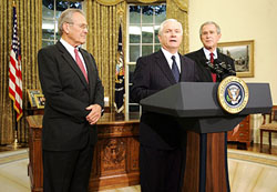 US President George W. Bush (R) looks at outgoing Defence Secretary Donald Rumsfeld (L) as his replacement, former CIA Director Robert Gates (C) speaks in the Oval Office of the White House