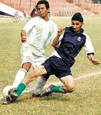Gurbaj (left) of Sanjay Public School being checked by Pardeep Singh of Moti Ram Arya School during a match in the under-19 football tournament in Sector 17, Chandigarh, on Friday. 