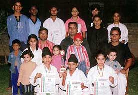 The karatekas of Anchal International Martial Arts Academy show their honours. Also seen in the picture are event officials.  A Tribune photograph
