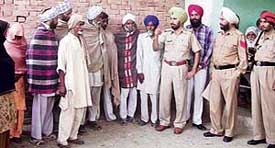 Mr Darshan Singh, SHO Sadar, talks to members of the Sainsi tribe at Jhuner village near Ahmedgarh on Saturday. 