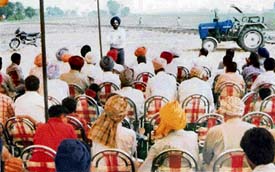 Dr Balwinder Singh Co-ordinator, laser levelling techniques, addresses farmers at Dharamgarh on Friday.