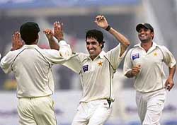 Wrecker-in-chief: Pakistans Umar Gul (centre) celebrates with team-mates Mohammad Hafeez (left) and Imran Farhat after dismissing West Indies skipper Brian Lara on the first day of the first Test at the Gaddafi Stadium in Lahore on Saturday. 
