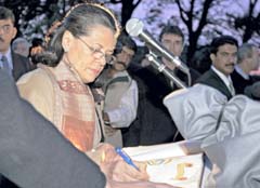 UPA Chairperson Sonia Gandhi signs the visitors book of the Last Post Association, after offering tribute at the memorial of Indian soldiers in Ieper city near Belgian-French border