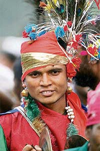 A tribal from Chhattisgarh performs during a peace march in New Delhi