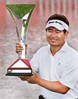 South Koreas Yang Yong-Eun holds the trophy after winning the HSBC Champions golf tournament at the Sheshan Golf Club in Shanghai on Sunday