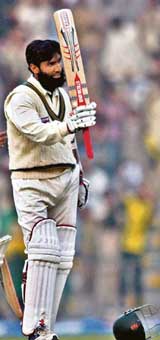 Pakistans Mohammad Yousuf raises his bat on completing his century during the second day of the first Test against the West Indies in Lahore on Sunday