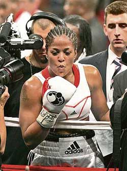 Boxer Laila Ali blows a kiss to her father Muhammad Ali after winning the WBC womens super middleweight title bout against Shelley Burton at the Madison Square Garden in New York on Saturday
