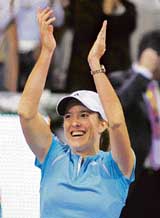 Belgiums Justine Henin-Hardenne celebrates after beating Frances Amelie Mauresmo in the final of the end-of-season WTA Tour Tennis Championship in Madrid on Sunday