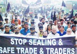 Traders holding a protest rally against the sealing drive at Raja Garden in the Capital