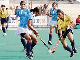 A Northern Railway player battles for the ball with a Pepsu defender during the womens semifinal of the 23rd Surjit Hockey Tournament at the Olympian Surjit Hockey Stadium in Jalandhar on Monday.