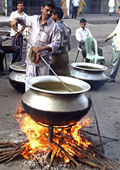 A man cooks food for supporters and workers engaged in blockades, outside the Awami League party office in Dhaka on Monday.