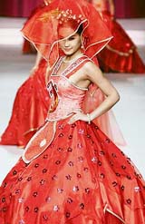 A model presents a creation for a wedding dress design contest at China Fashion Week in Beijing