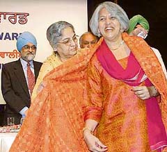 Ms Ishar Ahluwalia, wife of Dr Montek Singh Ahluwalia, being welcomed by Ms Gursharan Kaur while Mr Ahluwalia looks on at the Punjab Today award ceremony, in New Delhi 