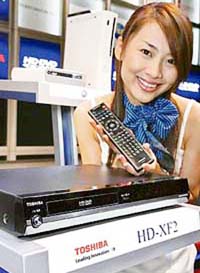A model displays Toshiba's second generation HD DVD player "HD-XF2", which is capable to playback pre-recorded HD DVD contents delivering digital high-definition images and PCM 5.1ch sound, in Tokyo