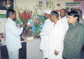 A group of farmers showing various varieties of the gladiolus flower at Haryana Pavilion at the India International Trade Fair.