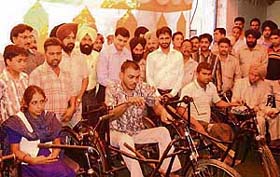SSP Shiv Kumar Verma distributes tricycles to needy people at Mandi Gobindgarh