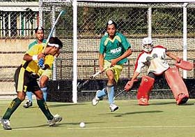 Players of the Javed Club of Pakistan try a shot against the Surjit Academy, Jalandhar, in the 5th All-India Jagtar Singh Memorial Hockey Tournament at Punjab Agricultural University, Ludhiana