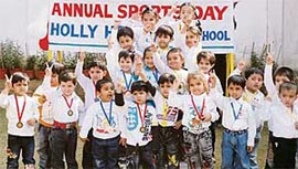 Tiny-tots of Hollyhock Nursery School celebrate their annual sports day in Ludhiana on Friday.