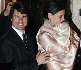 Superstars Tom Cruise and his fiance Katie Holmes, holding their daughter Suri, leave a restaurant in central Rome on Friday