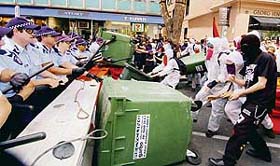 Hooded protesters attack a police blockade during the G-20 finance summit in Melbourne